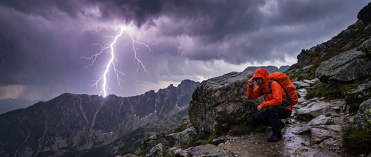 Hiker performing CPR on a lightning strike victim on a rocky mountain ridge, storm clouds and lightning visible in the background, first aid kit open nearby